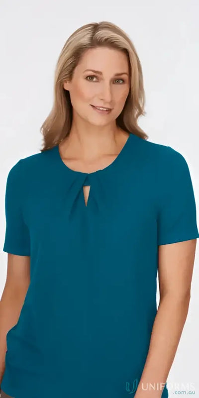 Woman in teal keyhole knit top with crepe texture, perfect for uniforms