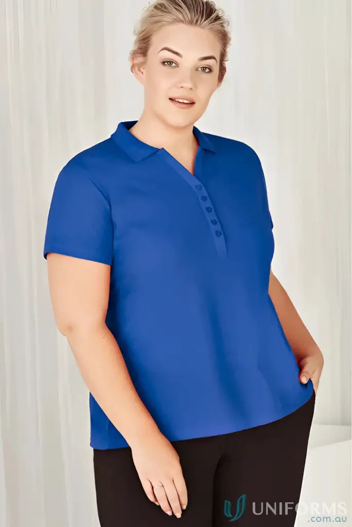 Plus-size woman in blue Talon Polo and black pants for workwear game look