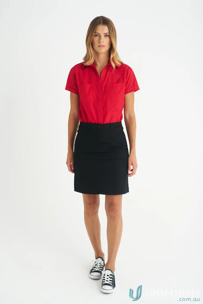 Woman wearing a red lily chino skirt with black and white sneakers for ladies lily chino style