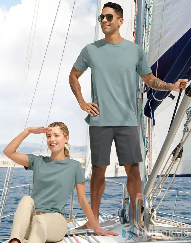 Two friends wearing matching Ladies Premium Mornington T-Shirts on a sailboat enjoying sunny day