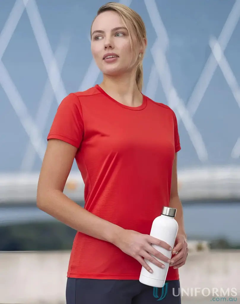 Woman holding white water bottle wearing Ladies RapidCool Ultra Light Tee athletic top