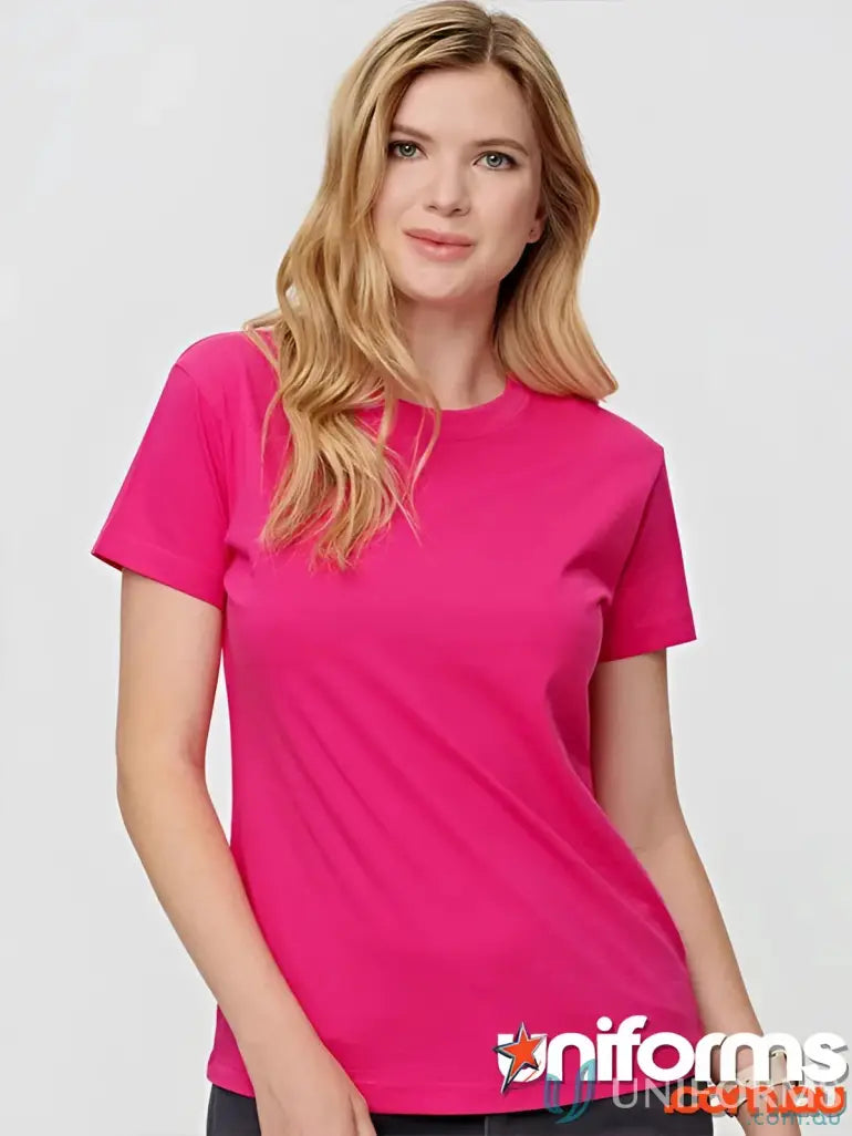 Woman wearing a pink Ladies Savvy Tee, part of the Ts38 Savvy collection, showcasing winning spirit ladies style