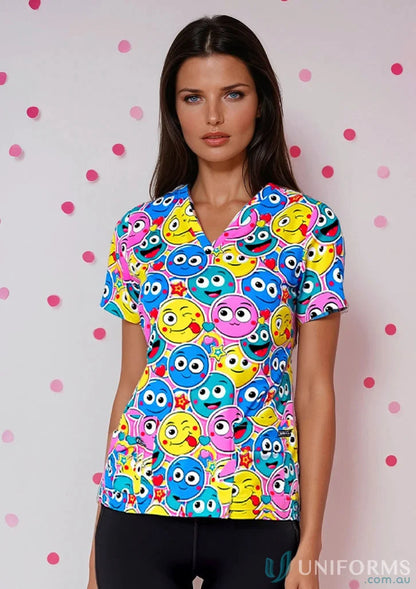 Woman wearing a colorful emoji-patterned 4stp1-smiley scrub top, perfect for beauty therapists uniforms