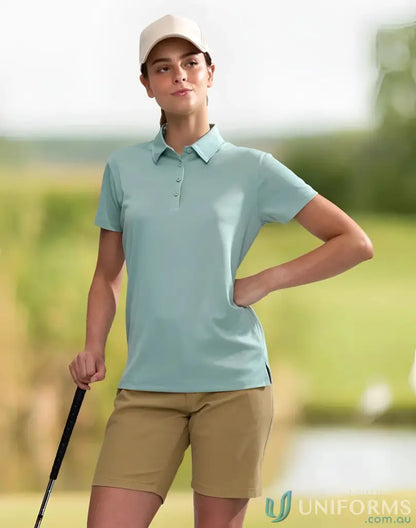 Woman in golf attire wearing Ladies Sustainable Jacquard Knit Polo, eco-friendly style