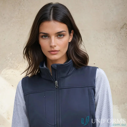 Woman wearing dark blue Ladies U:Tech SoftShell Vest from Biz Collection Women’s softshell vest j29123