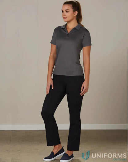 Woman in dark grey polo and black pants showcasing Ladies Utility Cargo Pant m9480
