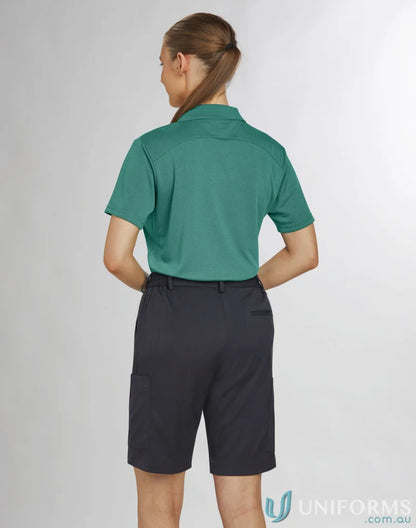 Lady wearing teal polo and dark gray Bermuda shorts from Ladies Utility Cargo collection