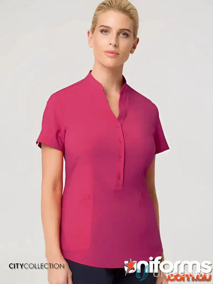 Lady wearing a pink city collection ladies zip back tunic made from recycled polyester