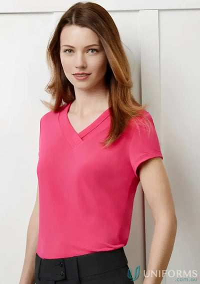 Woman wearing Lana Short Sleeve Top with fashionable pleat fold in soft pink jersey knit
