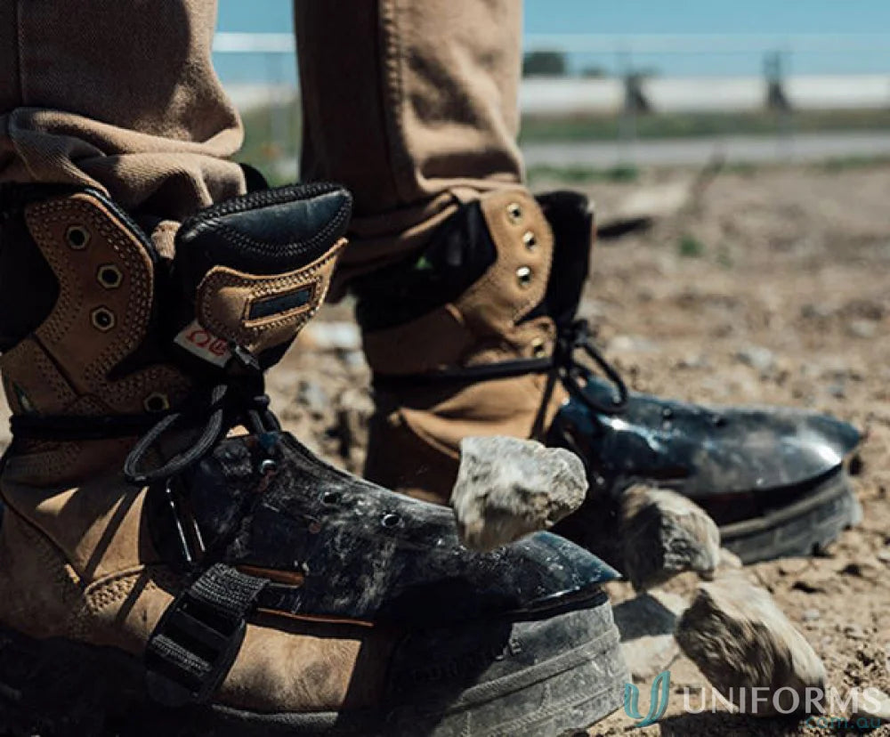 Worn work boots with toe protectors and boot straps for metatarsal guard upgrade