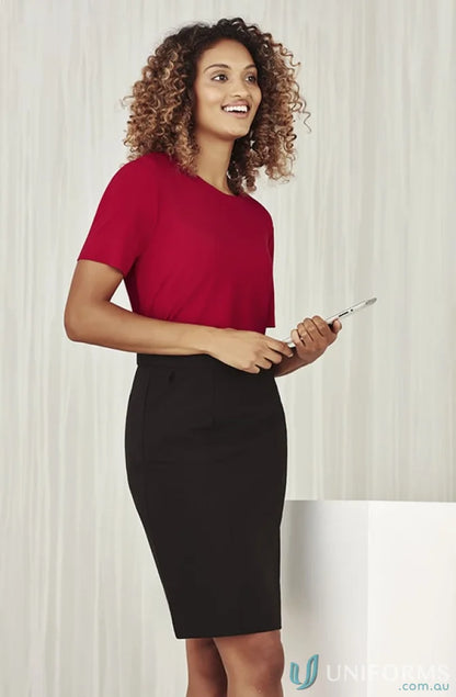 Woman in red top and black pencil skirt wearing Bizcare Marley Soft Jersey T-Top, perfect for women’s Marley short CS952LS short sleeve jersey style