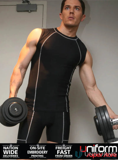 Man in black workout clothes lifting weights in Mens Compression Cropped Shorts for cropped bike shorts style
