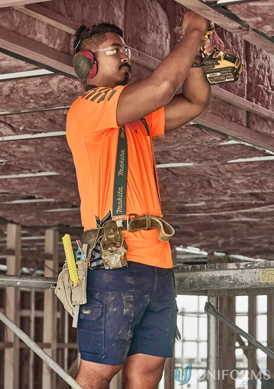 Construction worker using a drill in men’s stretch cargo shorts for ultimate men’s stretch comfort