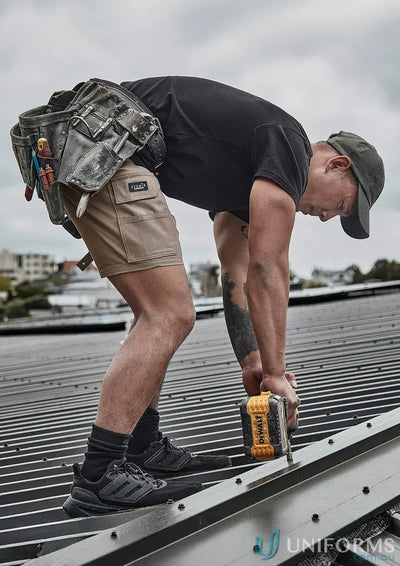 Roofer in Mens Essential Stretch Cargo Short using a DeWalt power drill outdoors