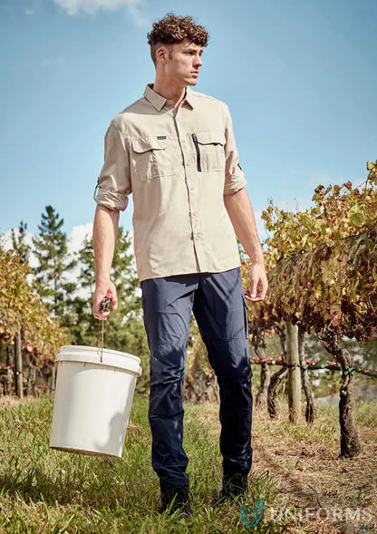 Man in outdoor clothing holding a bucket wearing Mens Lightweight Outdoor Pant with large cargo pocket for ultimate comfort