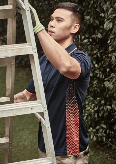 Mens Spark SS Polo: guy in navy blue shirt with orange breathable mesh side panel