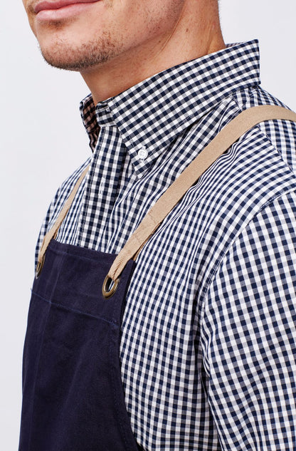 Navy blue corduroy apron with tan straps worn over Miller Gingham Check LS Shirt