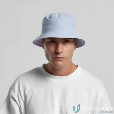 Man wearing a light blue nylon bucket hat, quick-dry recycled nylon design