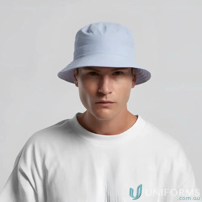 Man wearing a light blue nylon bucket hat, quick-dry recycled nylon design