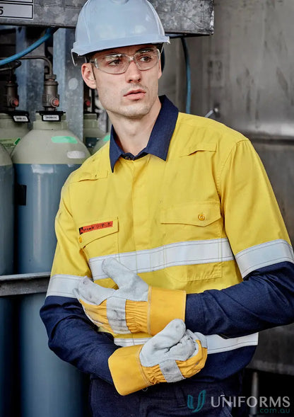 Man in yellow and navy ripstop spliced shirt with hard hat in demanding work environments