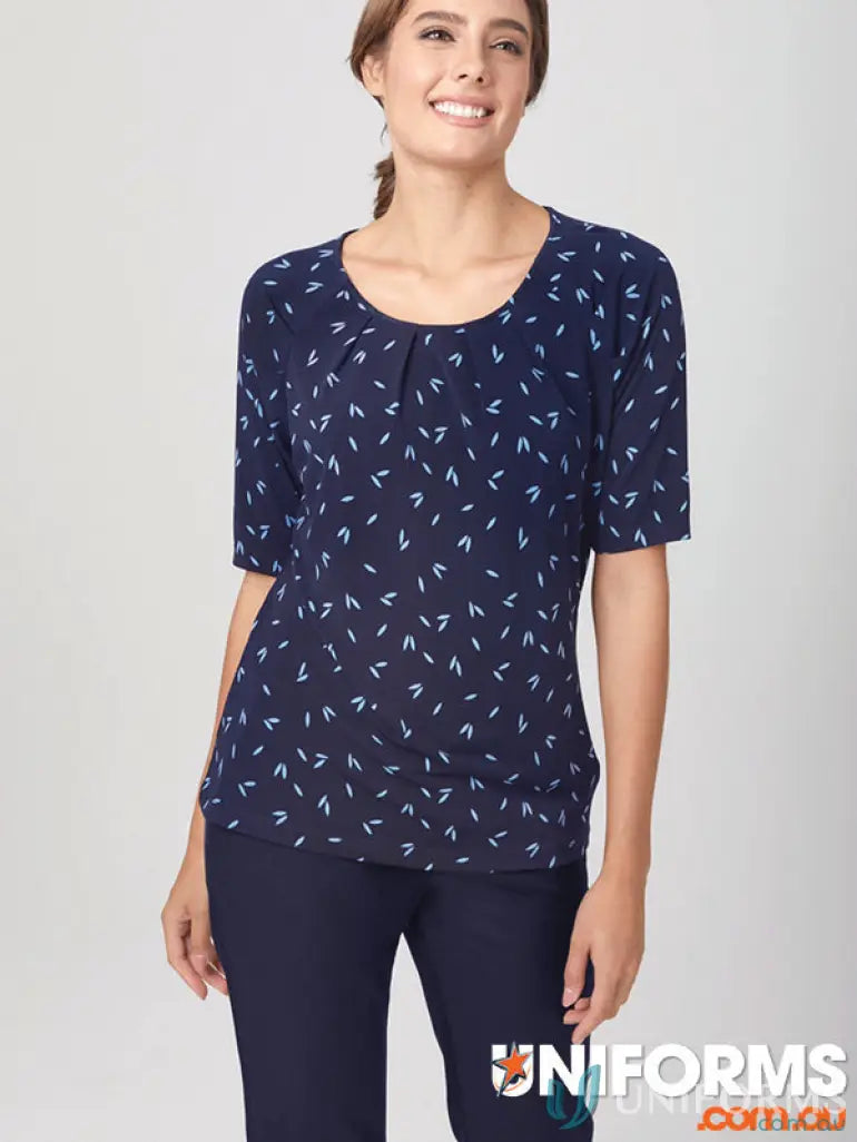 Woman wearing navy petal print knit top from City Collection Petal made with recycled polyester