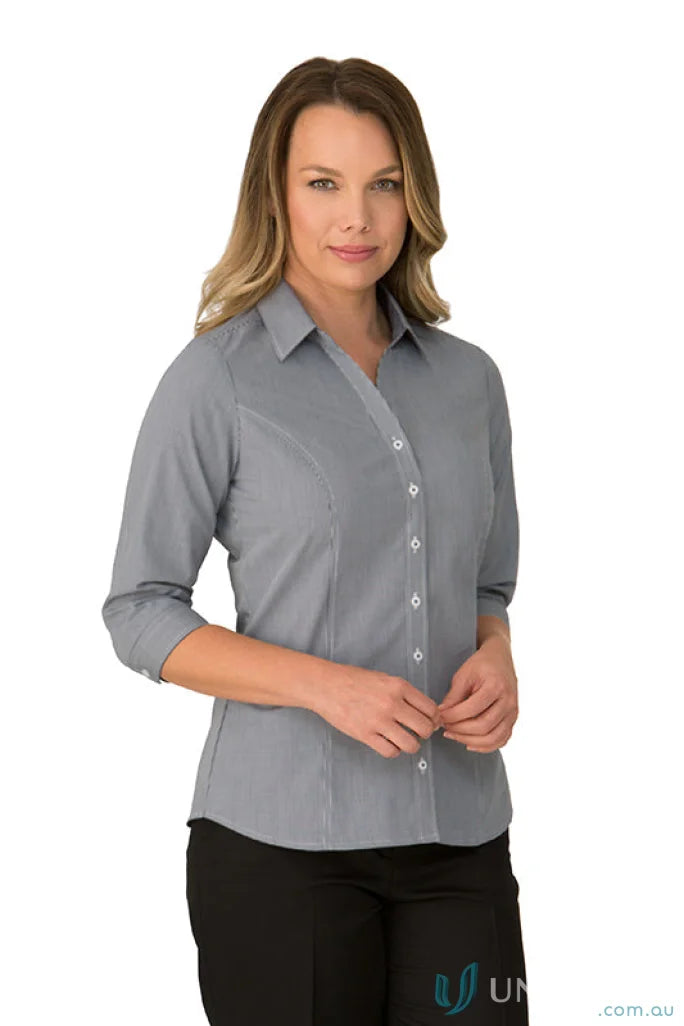 Woman in Pippa Check princess line workwear uniform with gray fitted shirt and black pants