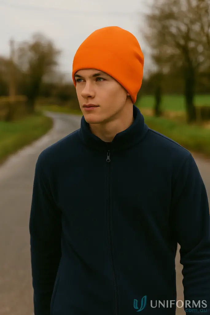 Orange fleece beanie on a person wearing the JBS Polar Beanie for cold weather
