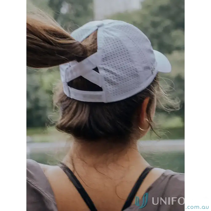 White perforated Ponytail Active Cap with unique ponytail opening and inbuilt cotton sweatband