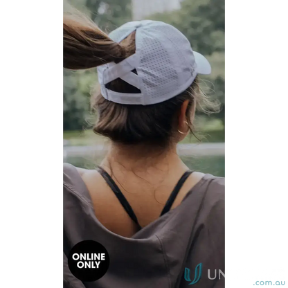 Woman wearing Planett Ponytail Cap with unique ponytail opening and inbuilt cotton sweatband