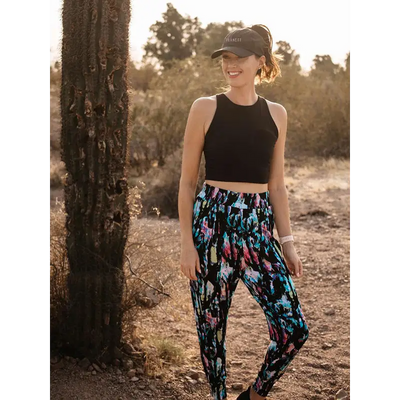 Black and multicolored floral leggings perfect for workwear or uniforms with ponytail active white cap detail