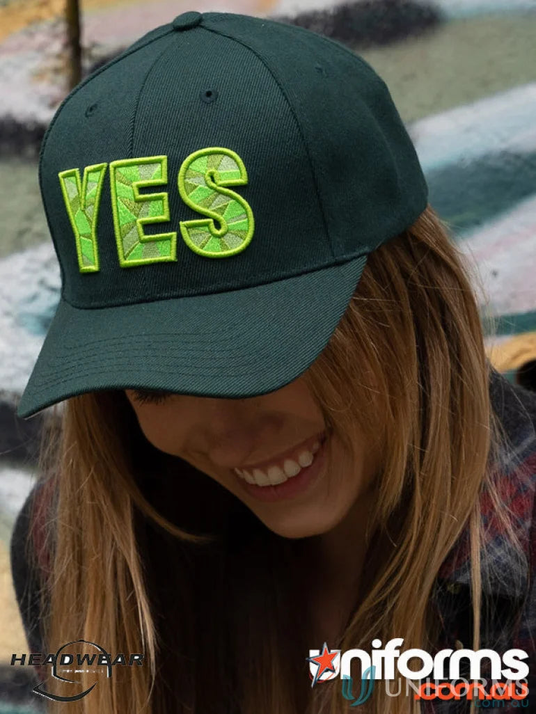 Green baseball cap made of premium American twill with a contrast peak and fabric-covered touch strap