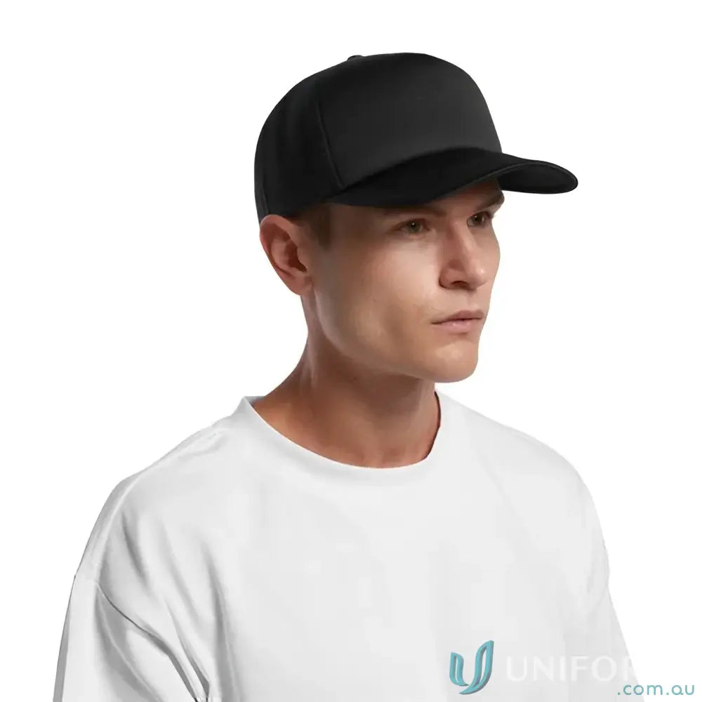 Man wearing a black baseball cap with recycled polyester mesh back and white t-shirt