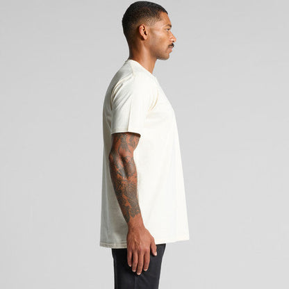 White pocket t-shirt with black pants and tattooed arm.