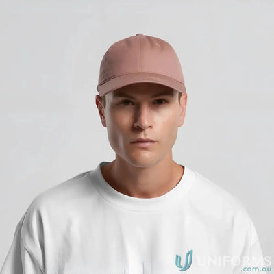 Light brown baseball cap with adjustable metal clasp on man’s head for a casual look