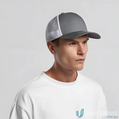 Man wearing grey and white recycled polyester mesh trucker cap with curved peak