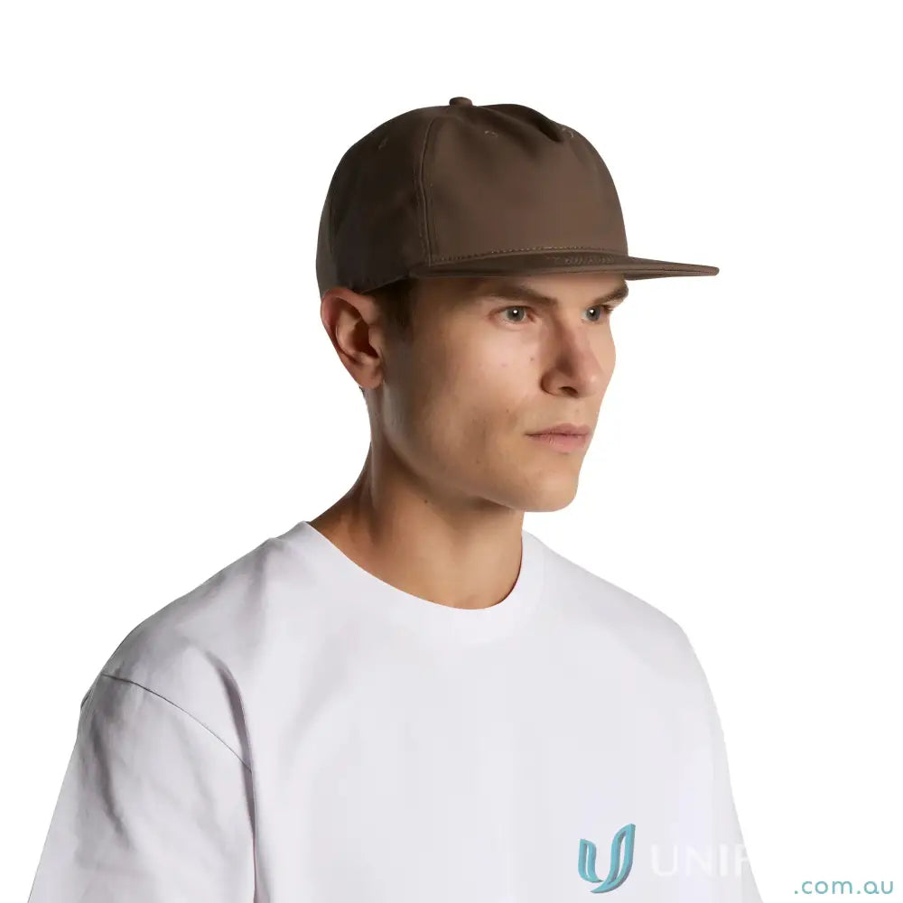Man wearing a white T-shirt and brown flat peak cotton canvas cap with plastic snapback