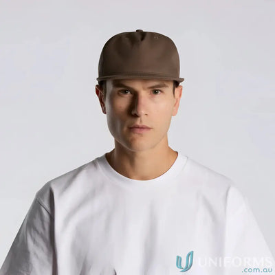 Man wearing a brown cotton canvas cap with flat peak and plastic snapback