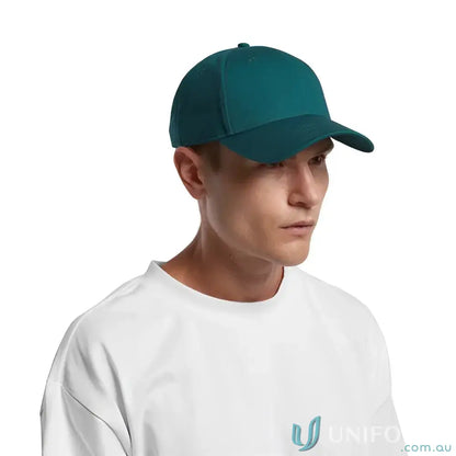 Man wearing a teal snapback cap with curved peak and tonal under-peak lining