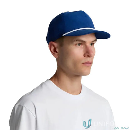 Man wearing royal blue unstructured five-panel cap with 16-wale partridge cord and matte nylon rope