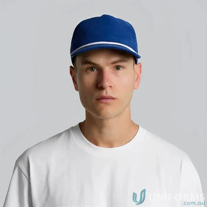 Man wearing blue unstructured five-panel cap with 16-wale partridge cord and matte nylon rope