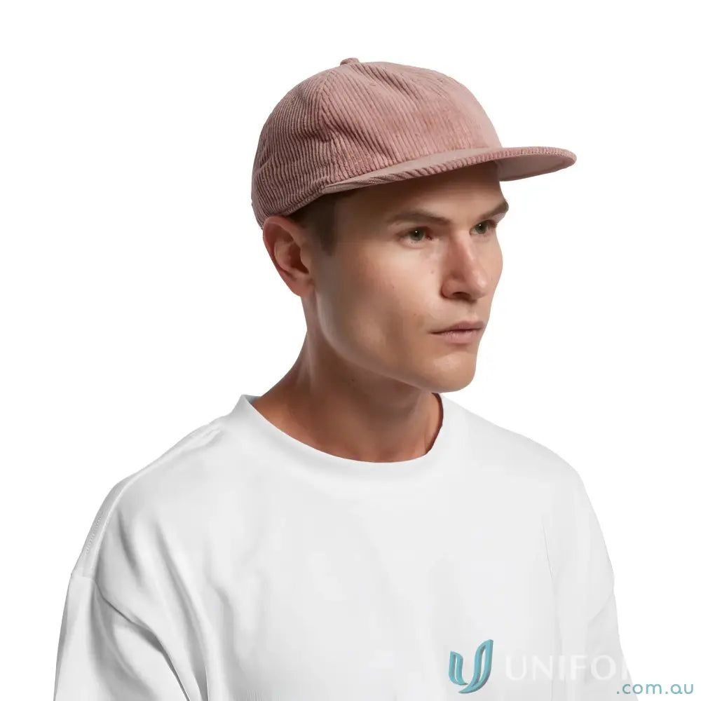 Man wearing pink 8-wale Partridge Cord unstructured six-panel cap with adjustable metal clasp