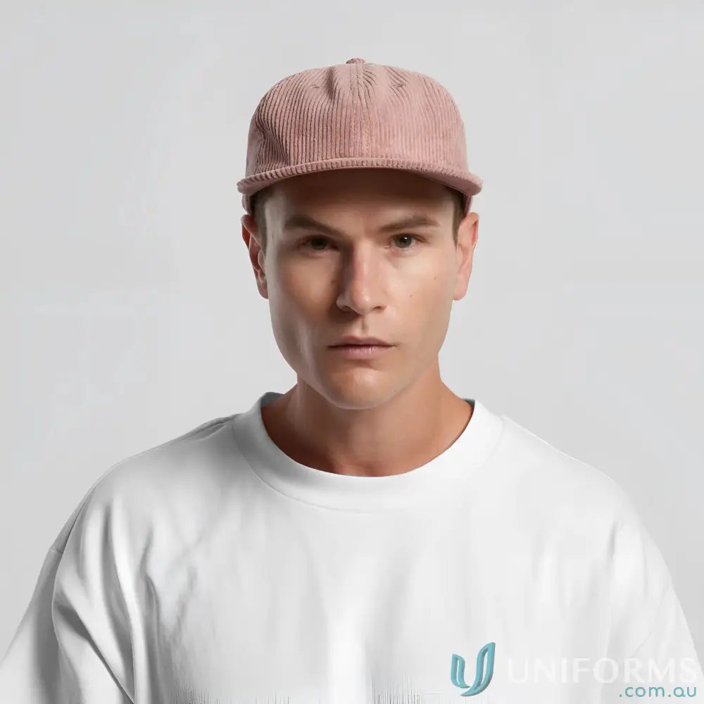 Man wearing a pink 8-wale partridge cord unstructured six-panel cap with adjustable metal clasp
