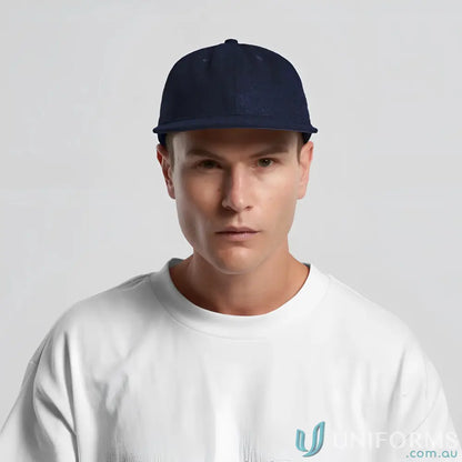 Man in navy blue flat-brimmed cap with adjustable metal clasp and tonal under-peak lining
