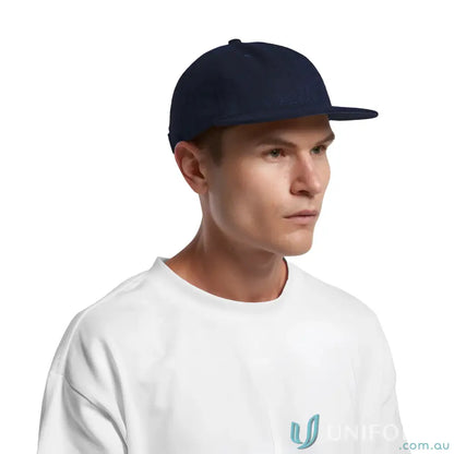 Man in navy blue flat-brimmed cap with adjustable metal clasp and tonal under-peak lining