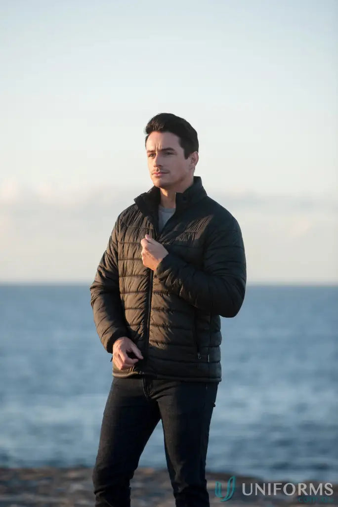 Man in a dark puffer jacket and jeans, perfect for workwear or uniforms