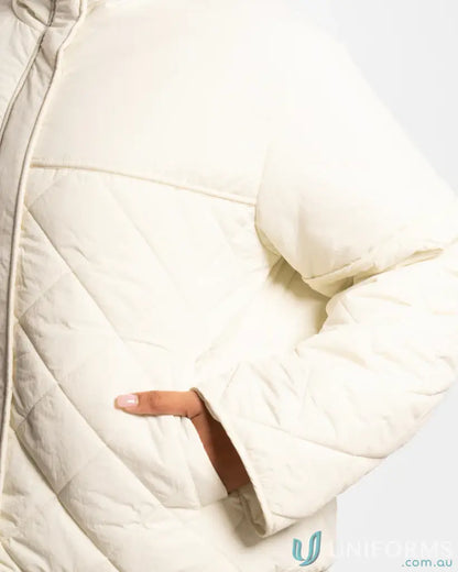 Cream-colored quilted puffer jacket with internal zip pocket and high stand-up collar