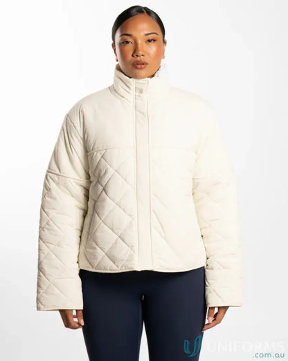 Cream-colored quilted puffer jacket with high stand-up collar and internal zip pocket