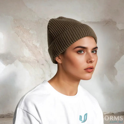 Woman wearing a recycled wool gauge beanie in olive green with a white shirt