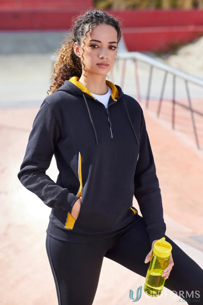 Woman in black and yellow athletic wear with reflective trims, showcasing the Renegade Hoodie