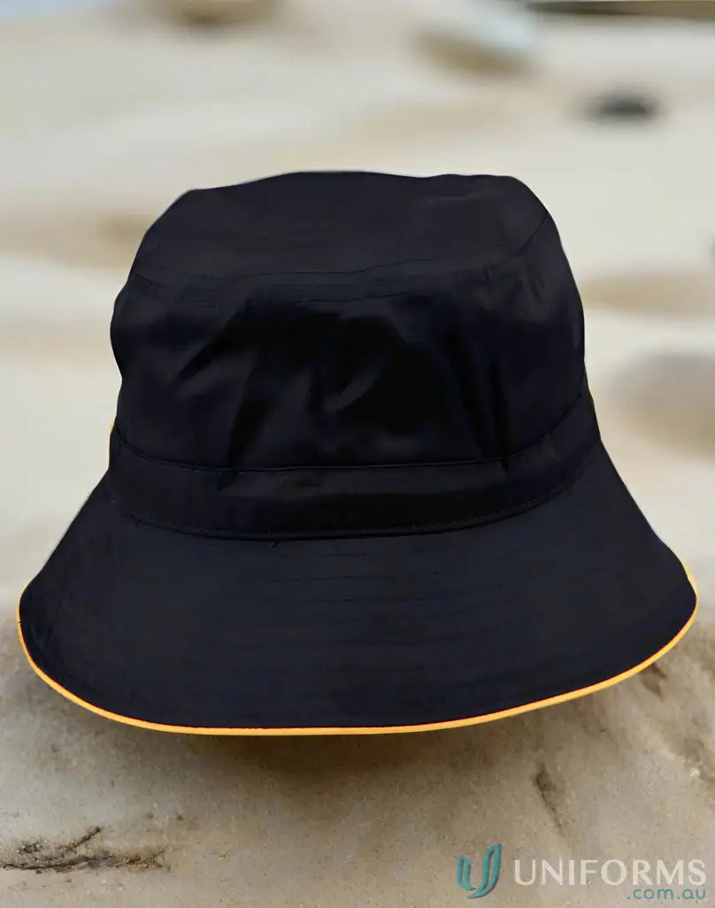 Black bucket hat with orange trim from H1033 Sandwich Bucket for winning spirit and sun protection
